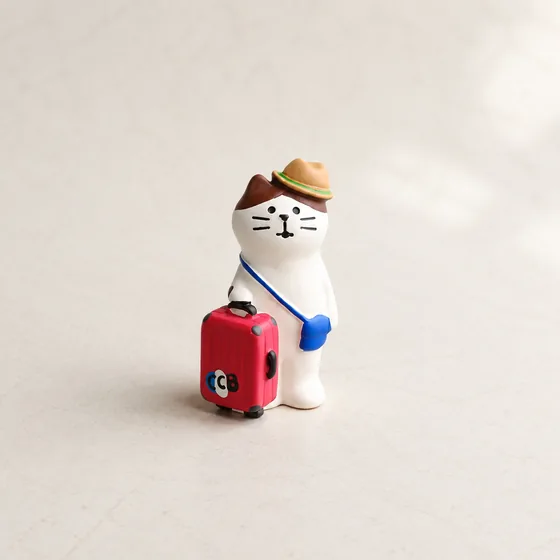 Kitten carrying red suitcase